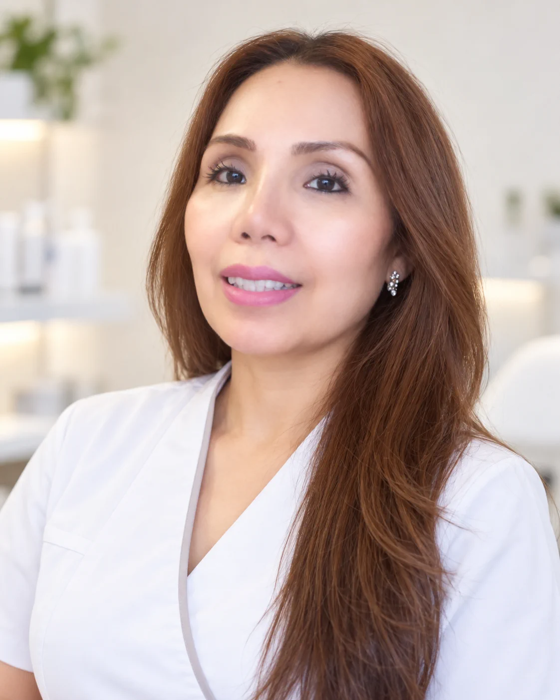 Welda, qualified Aesthetician and Dermal Therapist at Skintastic Skin & Beauty, smiling in a white uniform