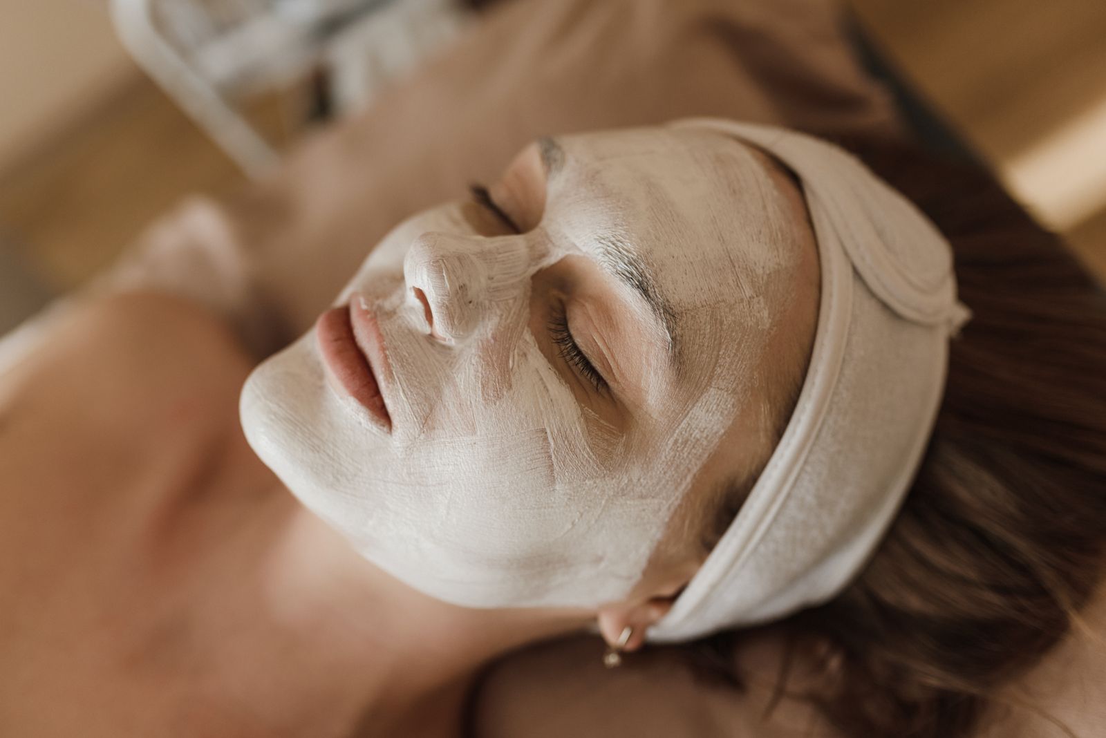 Editorial image of a professional facial treatment in progress.