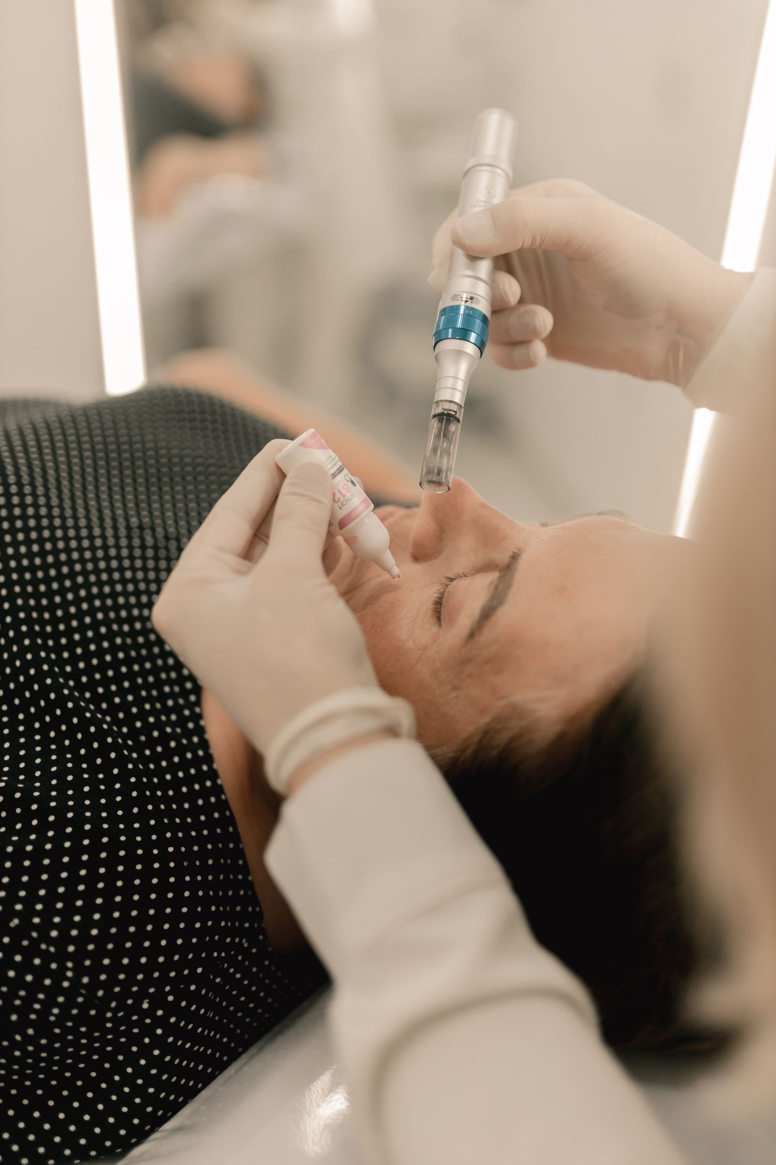 Editorial close-up of a microneedling treatment with a pen-like device.